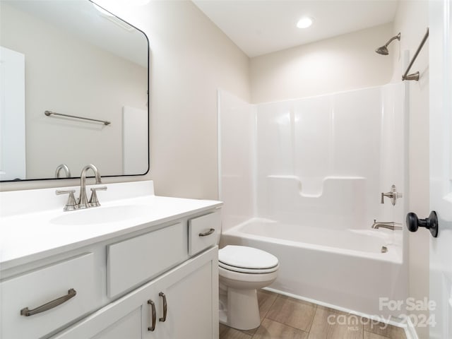 full bathroom with wood-type flooring, shower / bath combination, vanity, and toilet