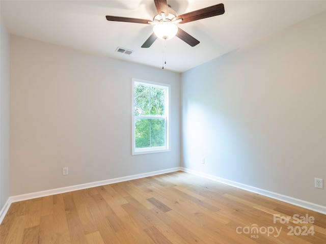 spare room featuring ceiling fan and light hardwood / wood-style flooring