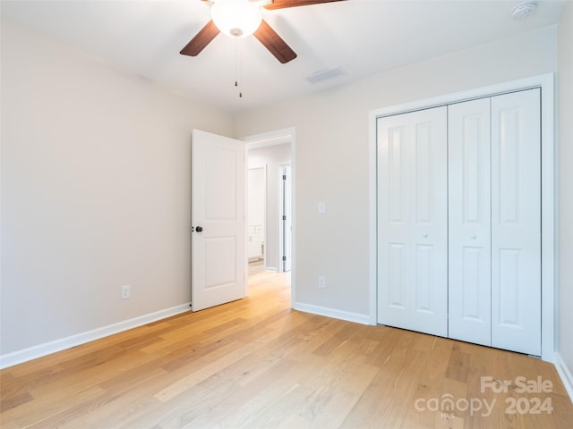 unfurnished bedroom featuring ceiling fan, a closet, and light hardwood / wood-style floors