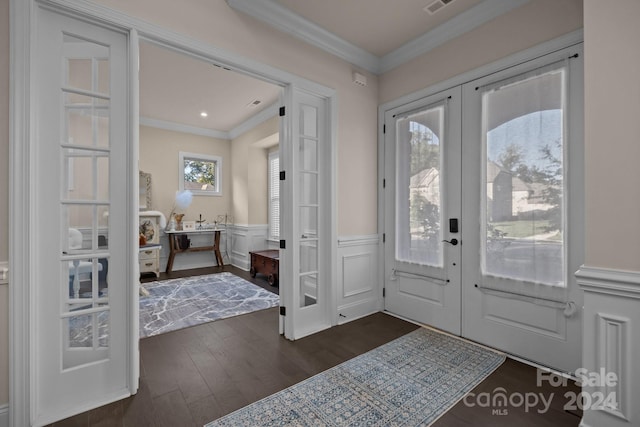 foyer with french doors, ornamental molding, plenty of natural light, and dark wood-type flooring