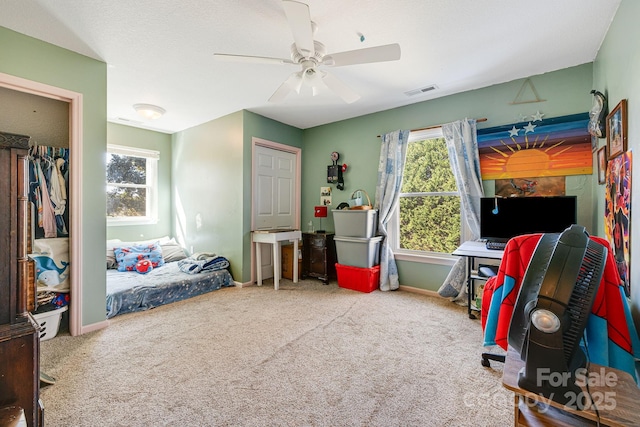 carpeted bedroom featuring ceiling fan