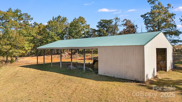 view of outbuilding featuring a lawn