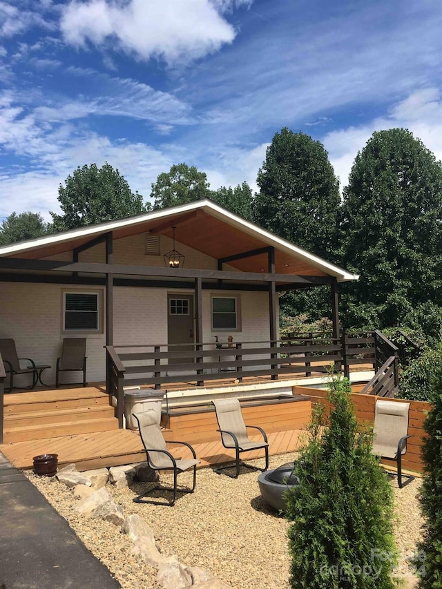 view of front of property featuring a fire pit and a wooden deck