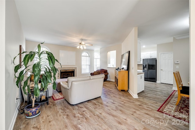 living room featuring light hardwood / wood-style flooring and ceiling fan