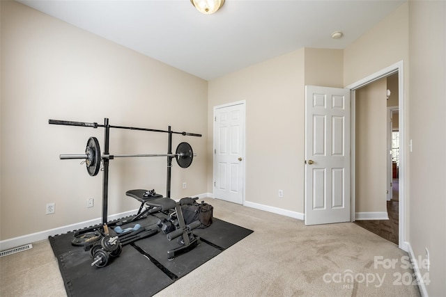 exercise room with light colored carpet