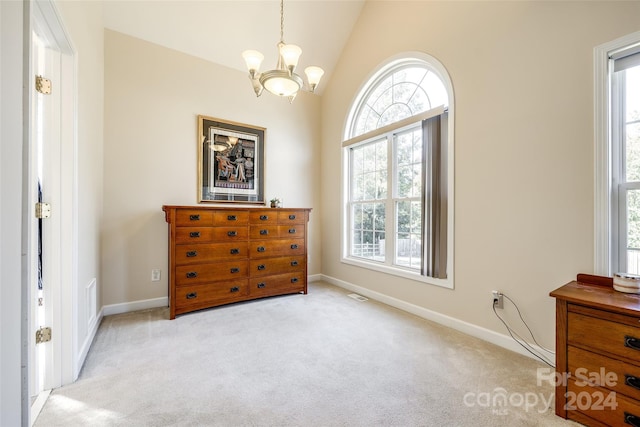 carpeted bedroom featuring vaulted ceiling and a chandelier