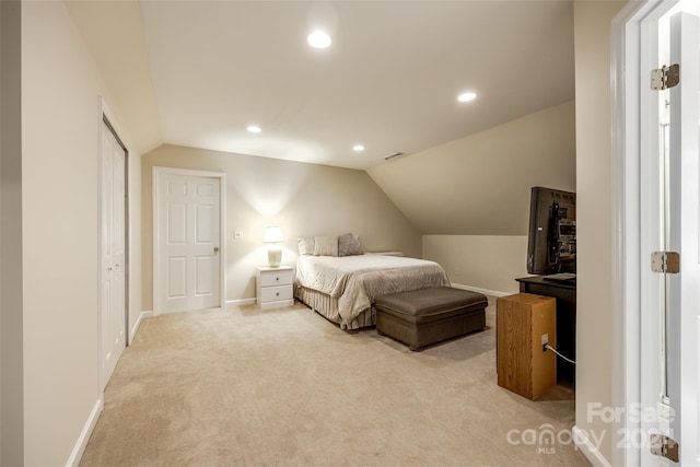 carpeted bedroom with lofted ceiling