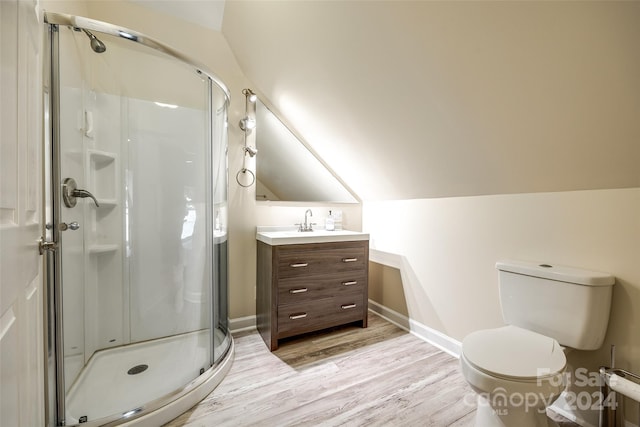 bathroom with vanity, lofted ceiling, a shower with door, and hardwood / wood-style floors