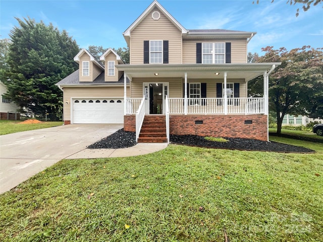 view of property featuring a garage, a front lawn, and covered porch