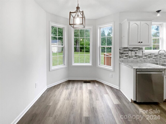 kitchen with white cabinets, dishwasher, pendant lighting, and a wealth of natural light