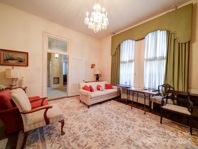 living area featuring crown molding and an inviting chandelier