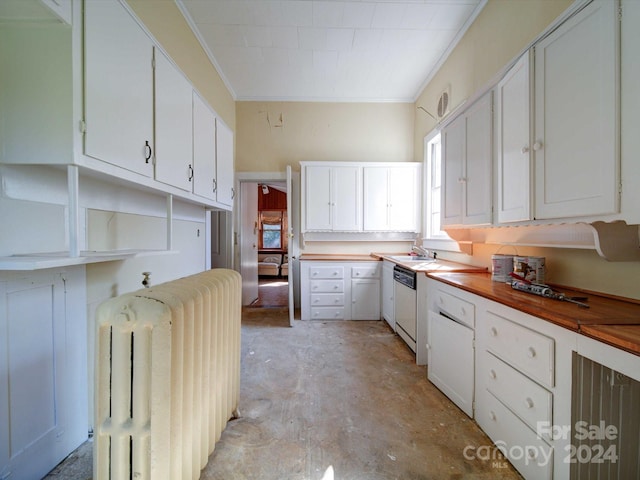 kitchen featuring ornamental molding, white cabinets, wooden counters, and white dishwasher