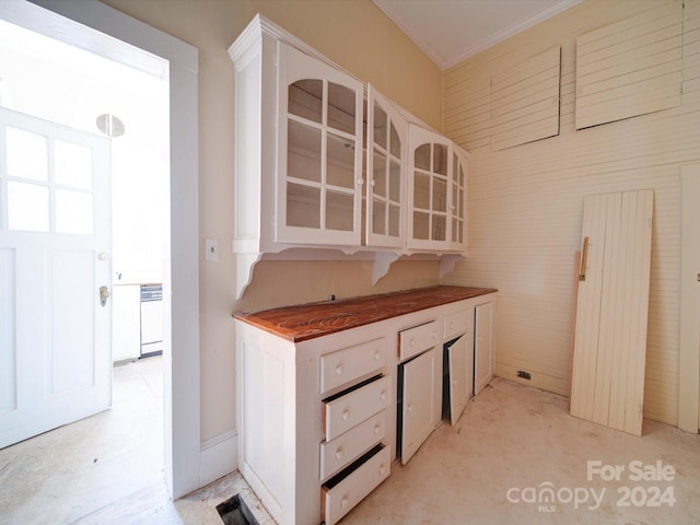 kitchen featuring white cabinetry, white dishwasher, and wooden counters