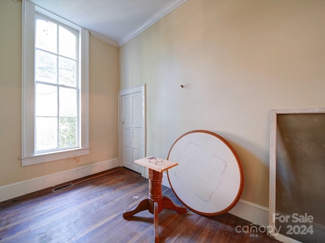 sitting room with crown molding and hardwood / wood-style floors