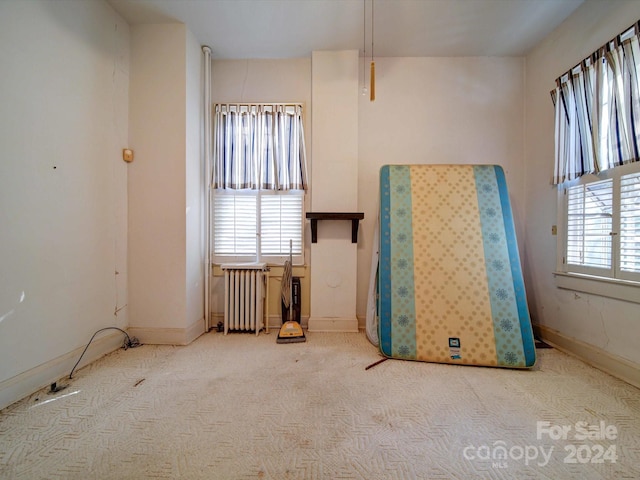 carpeted spare room with radiator heating unit