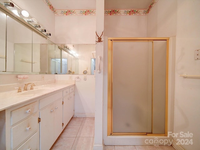 bathroom with vanity, walk in shower, and tile patterned flooring