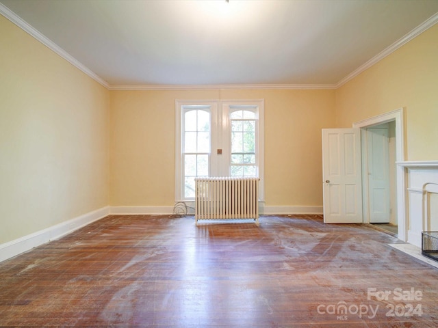 empty room featuring crown molding and hardwood / wood-style floors