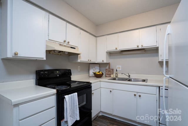 kitchen featuring sink, white appliances, a textured ceiling, white cabinetry, and dark hardwood / wood-style flooring