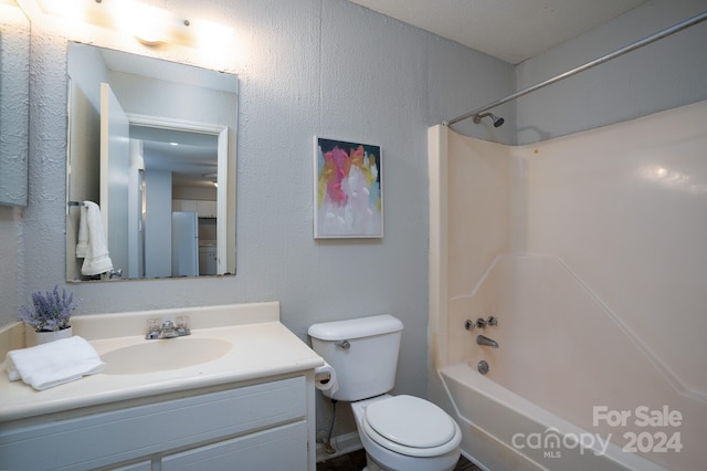 full bathroom featuring vanity, toilet, and  shower combination