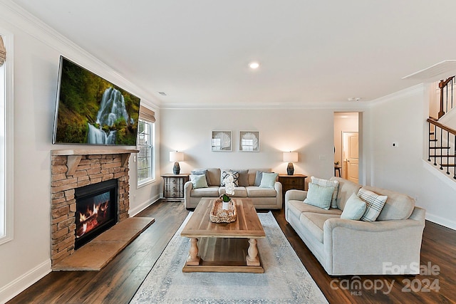 living room featuring crown molding, a fireplace, and dark wood-type flooring