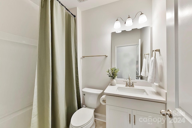 bathroom featuring walk in shower, vanity, and toilet