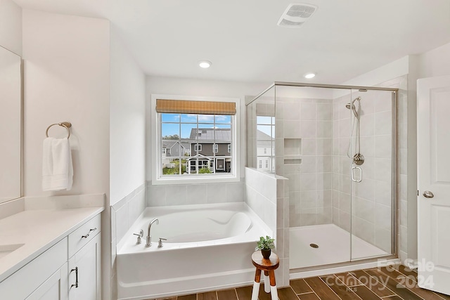 bathroom with vanity and separate shower and tub