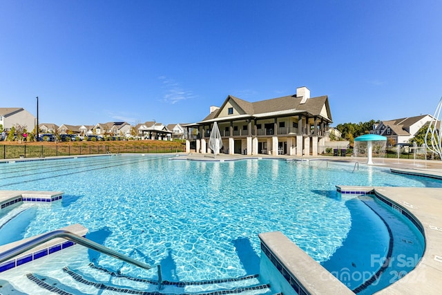 view of swimming pool with pool water feature, a patio, and a jacuzzi