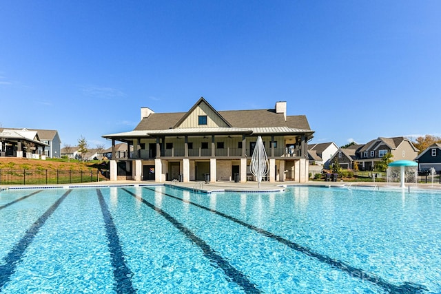 view of pool with a patio area and pool water feature