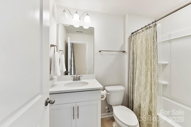 bathroom featuring visible vents, toilet, and vanity