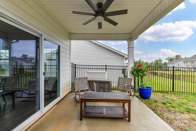 view of patio / terrace with ceiling fan and fence