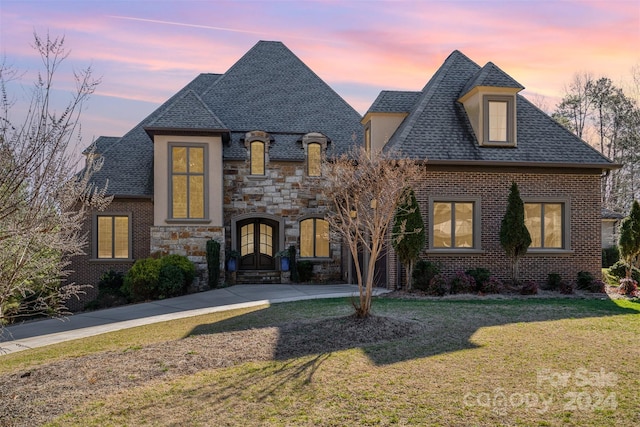 french country home with a lawn and french doors