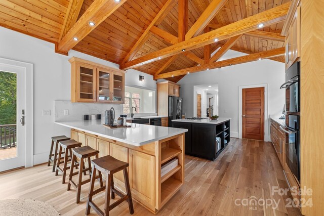 kitchen featuring a wealth of natural light, wooden ceiling, and a kitchen island