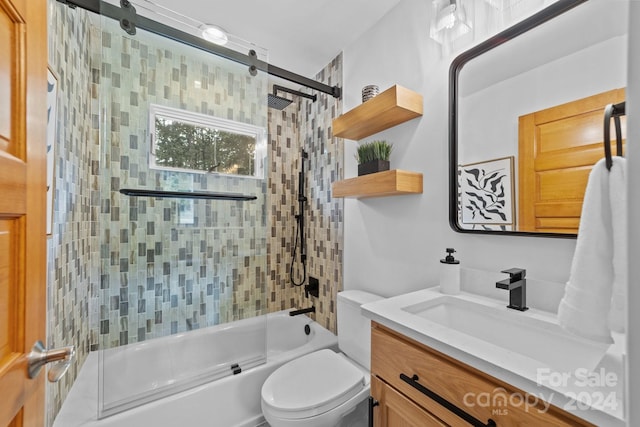 full bathroom with vanity, tiled shower / bath combo, and toilet