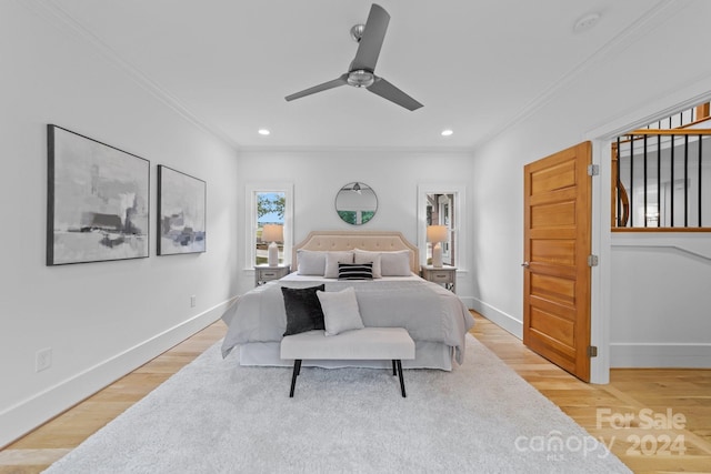 bedroom with ceiling fan, light wood-type flooring, and crown molding