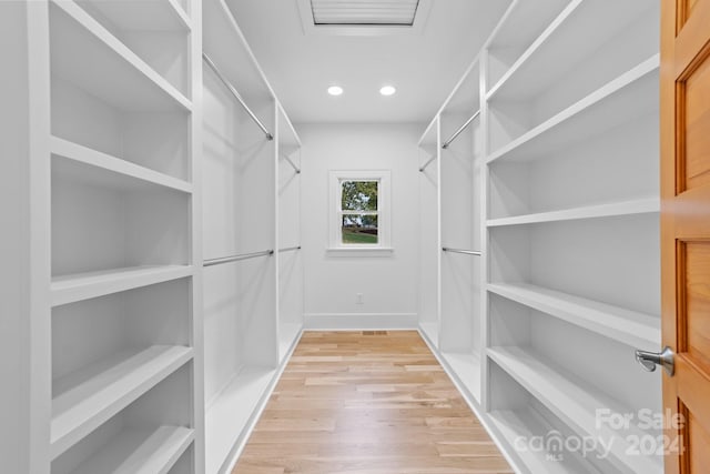 spacious closet with light hardwood / wood-style flooring