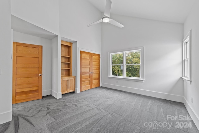 unfurnished bedroom with high vaulted ceiling, ceiling fan, and carpet floors