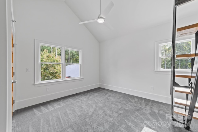 empty room featuring a healthy amount of sunlight, carpet, and ceiling fan