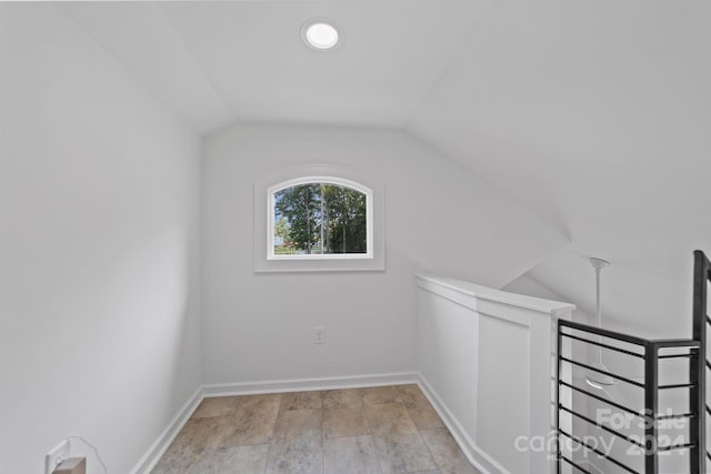 bonus room featuring lofted ceiling and light hardwood / wood-style floors