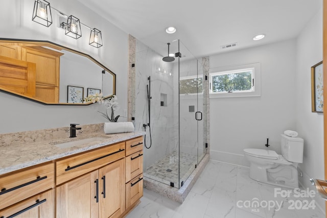 bathroom featuring vanity, an enclosed shower, and toilet