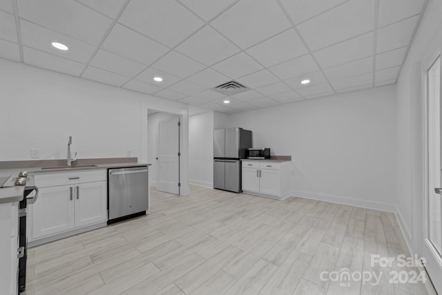 kitchen featuring light wood-type flooring, white cabinetry, sink, and stainless steel appliances