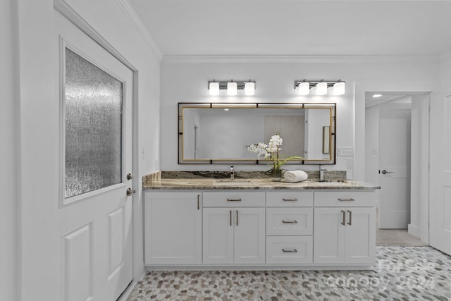 bathroom with ornamental molding and vanity