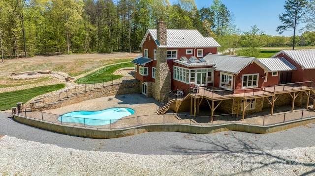 back of property with a deck and a patio area