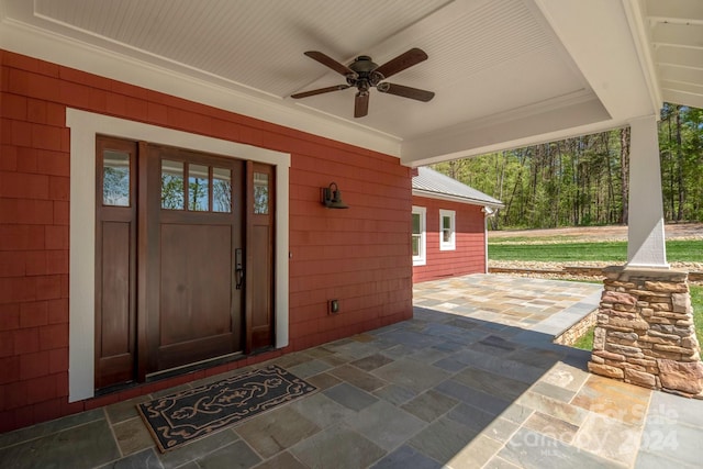 exterior space featuring ceiling fan and crown molding