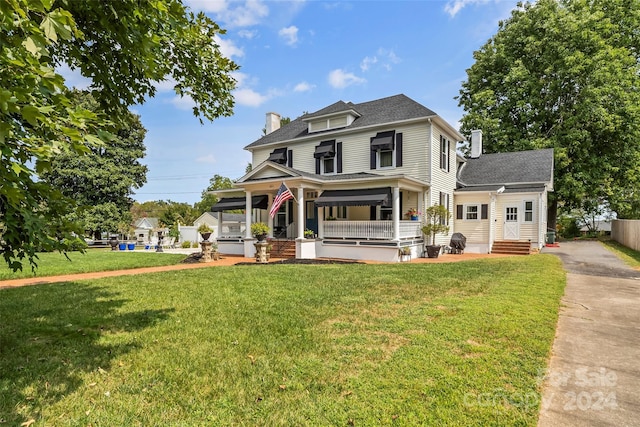 404 Avery Ave, Morganton, NC 28655 - view of front facade with a chimney, covered porch, a front lawn, and roof with shingles