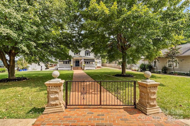 obstructed view of property with a gazebo and a front yard