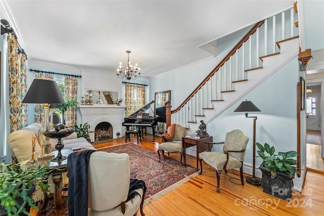 404 Avery Ave, Morganton, NC 28655 - living area featuring stairs, crown molding, wood finished floors, a chandelier, and a fireplace with flush hearth
