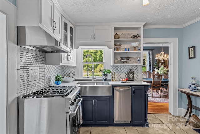 kitchen with decorative backsplash, stainless steel stove, white cabinetry, and ventilation hood