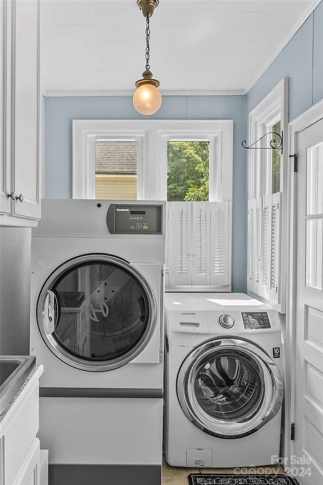 404 Avery Ave, Morganton, NC 28655 - laundry area with washer and clothes dryer, cabinet space, and ornamental molding
