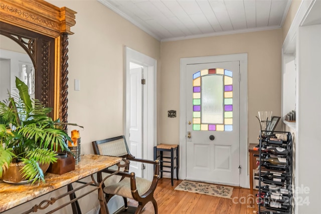 foyer with hardwood / wood-style floors and ornamental molding