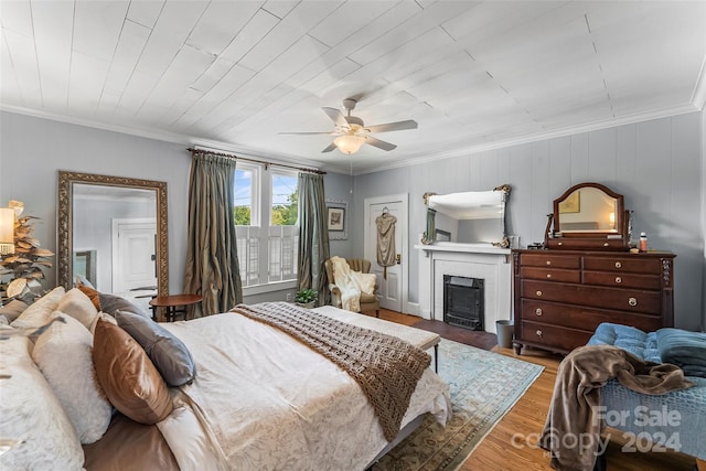 404 Avery Ave, Morganton, NC 28655 - bedroom featuring crown molding, wood finished floors, a fireplace, and a ceiling fan